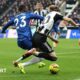 Newcastle forward Anthony Gordon is challenged inside the box by Chelsea defender Trevoh Chalobah