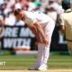 England bowler Gus Atkinson bends over to hold is legs with an apparent hamstring injury