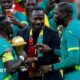 Pape Thiaw and the Senegal players celebrate with the trophy after winning the Africa Cup of Nations