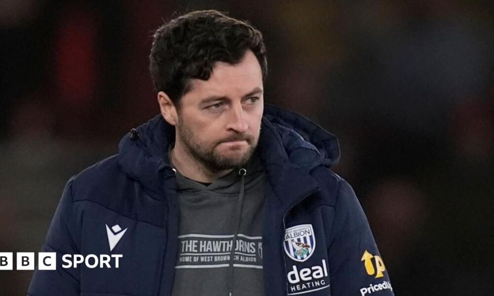 Ryan Mason sits in the dugout during a match