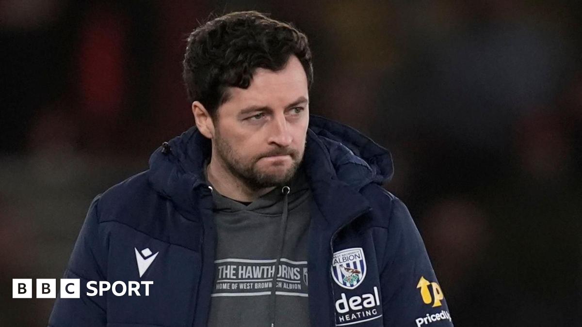 Ryan Mason sits in the dugout during a match