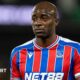 Jean-Philippe Mateta wearing a blue and red striped Crystal Palace shirt