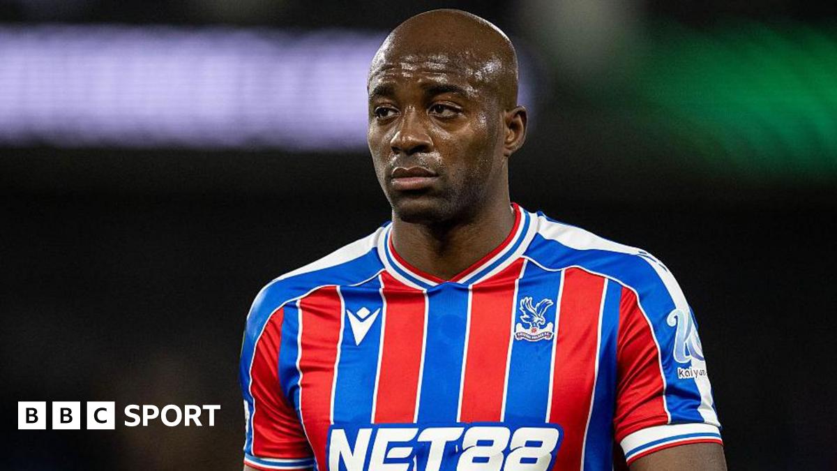 Jean-Philippe Mateta wearing a blue and red striped Crystal Palace shirt