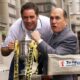 Ally McCoist and Robert Duvall hold the Scottish Cup. Duvall is in a director's chair while McCoist is leaning forward in a white T-shirt.