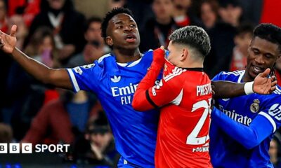 Real Madrid's Vinicius Junior reacts after an interaction with Benfica's Gianluca Prestianni