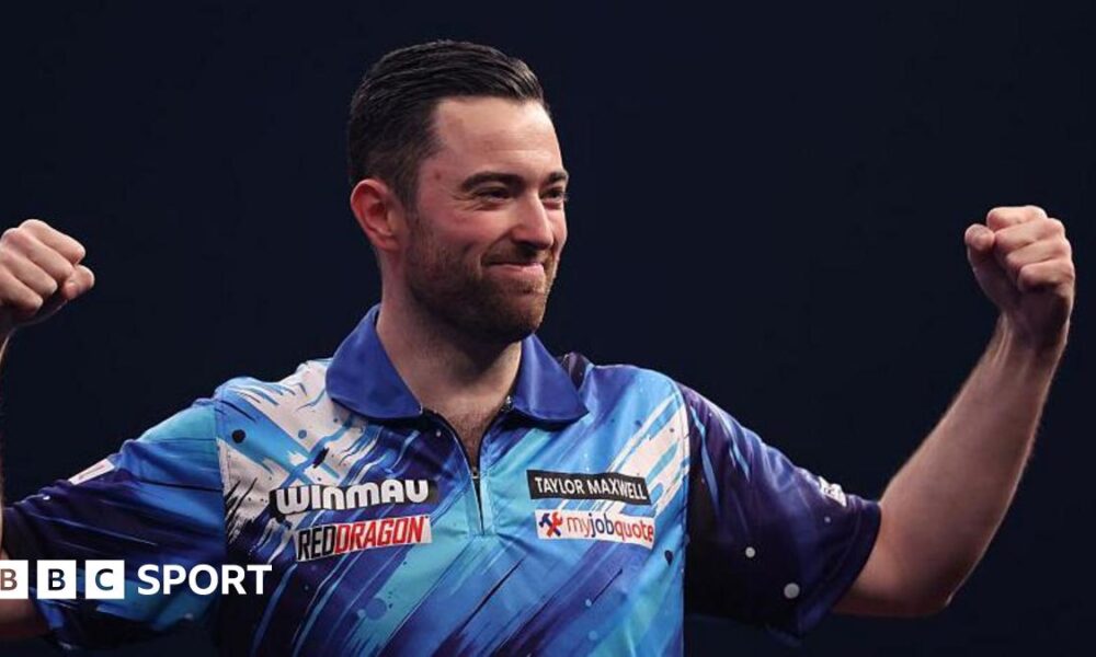 Luke Humphries raises his fists to celebrate after hitting a nine-darter at the World Masters