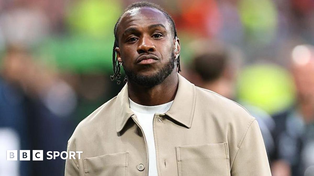Michail Antonio on a pitch for the Conference League final while working as a pundit