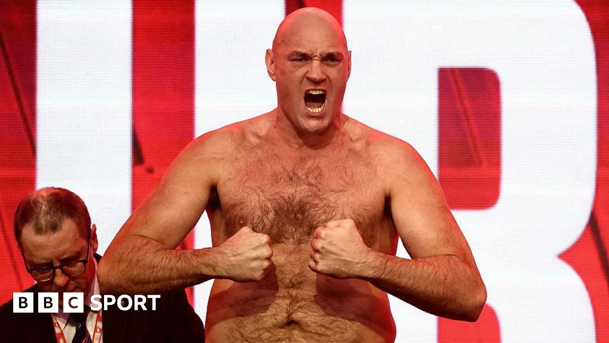 Tyson Fury tenses for the cameras at the weigh-in