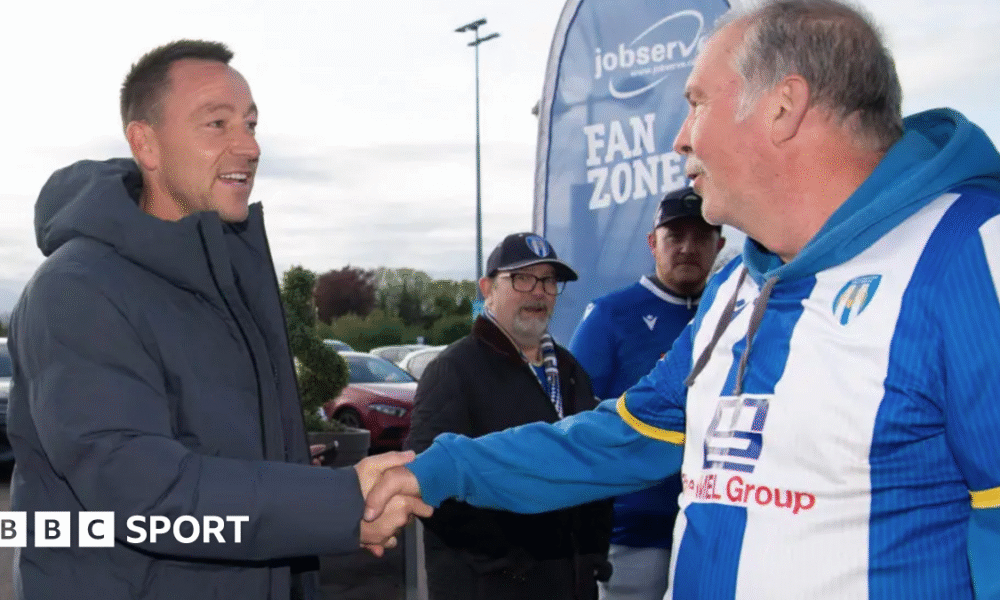 John Terry shakes hands with a Colchester fan