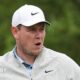 Robert MacIntyre in grey golf fleece and white cap during the final round of the Texas Open, with greenery in the background