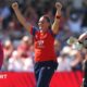 Dani Gibson raises her hands in the air to celebrate the wicket of Maddy Green