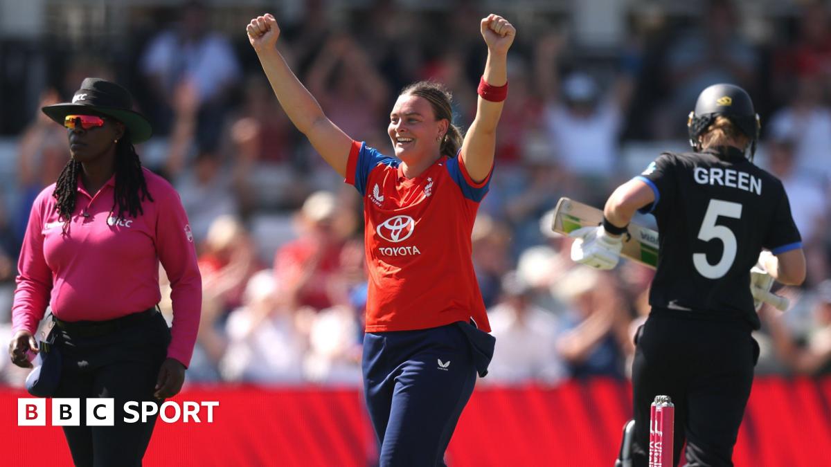 Dani Gibson raises her hands in the air to celebrate the wicket of Maddy Green