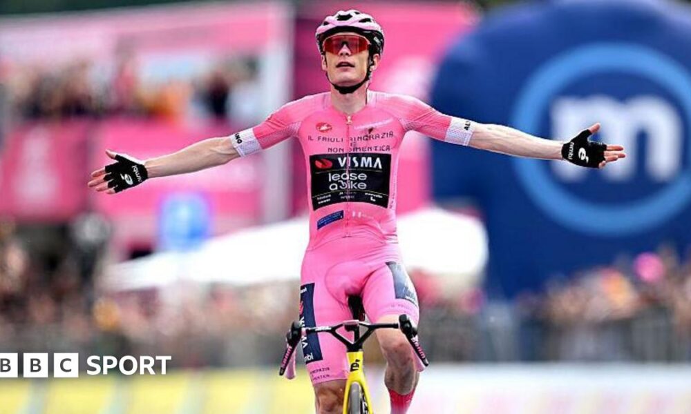 Jonas Vingegaard raises his arms as he crosses the finish line