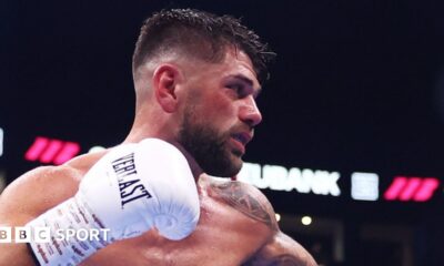 Joe Cordina side-on in the ring with gloved right fist raised