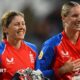 Alice Capsey is hugged by a team-mate