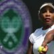 Serena Williams prepares to toss a tennis ball in practice at Wimbledon
