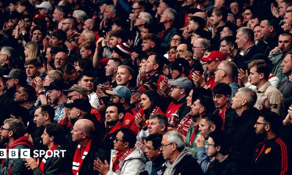 Manchester United fans applaud before kick off of a Premier League fixture against Liverpool