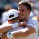 Henry Patten embraces team-mate Harri Heliovaara after winning the Wimbledon men's doubles title