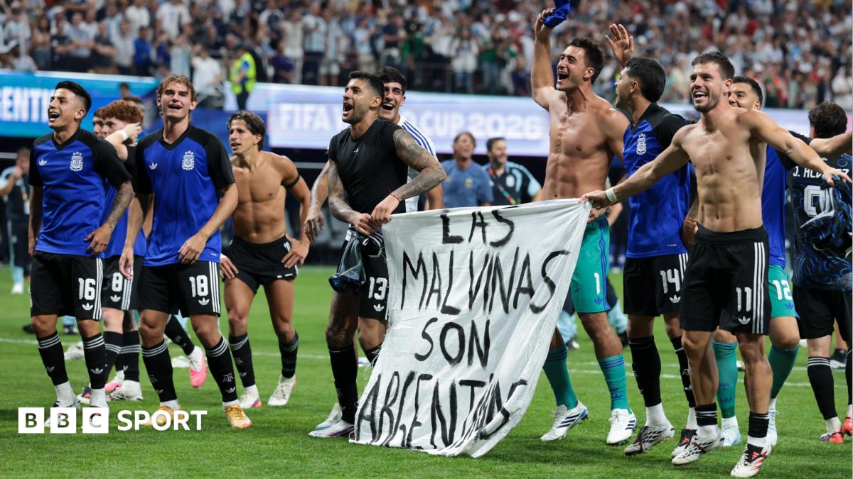 Argentina players celebrate at full-time with a banner that reads "The Falkland Islands are Argentine" after beating England in the World Cup 2026 semi-final