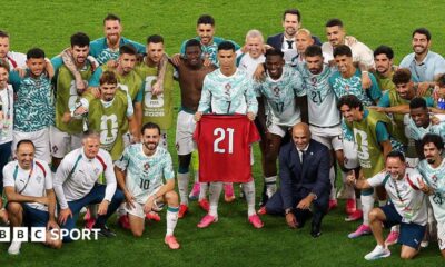 Cristiano Ronaldo holds Diogo Jota's '21' shirt aloft for Portugal