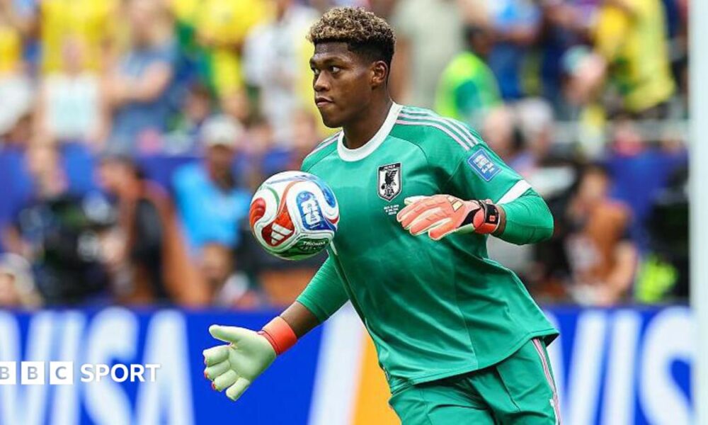 Zion Suzuki controls the ball with his chest while playing for Japan at the World Cup