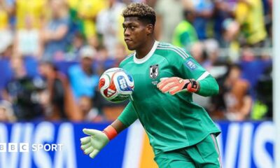 Zion Suzuki controls the ball with his chest while playing for Japan at the World Cup