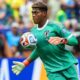 Zion Suzuki controls the ball with his chest while playing for Japan at the World Cup