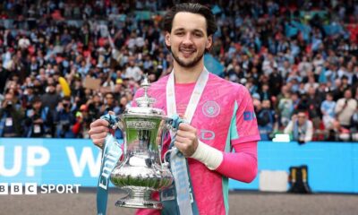 Manchester City goalkeeper James Trafford holding the FA Cup trophy at Wembley Stadium