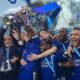 Claudio Ranieri with the Premier League trophy and a crown being put on his head