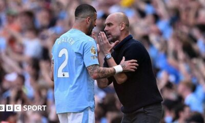 Kyle Walker and Pep Guardiola have a discussion on the touchline.