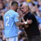 Kyle Walker and Pep Guardiola have a discussion on the touchline.
