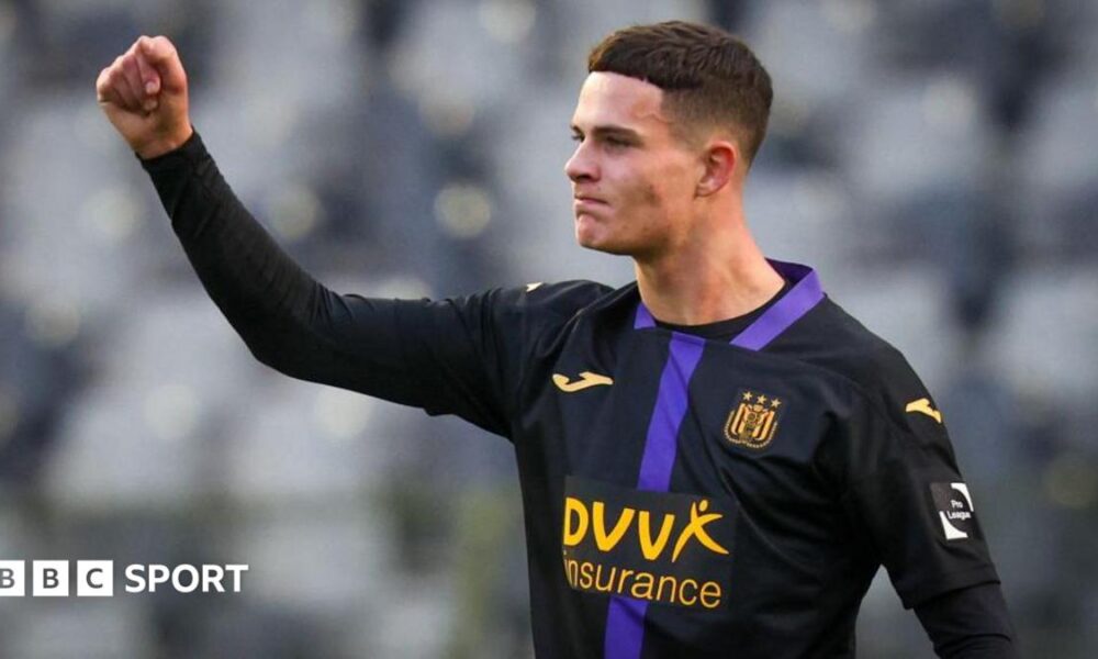 Robbie Ure punches the air while wearing the largely black kit of his former team Anderlecht