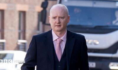 Graeme Dott arriving at the High Court in Glasgow. He is wearing a dark suit over a pink shirt witha pink tie.