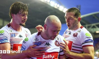 Liam Marshall (centre) celebrates scoring one of his tries for Wigan Warriors