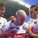 Liam Marshall (centre) celebrates scoring one of his tries for Wigan Warriors