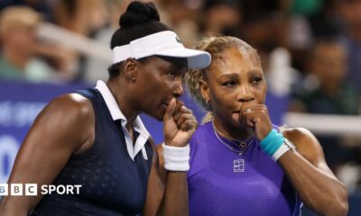 Venus Williams (left) speaks to Serena Williams during their US Open first-round doubles match in 2022