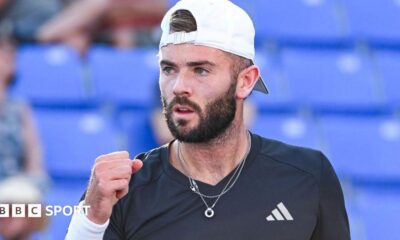 Jacob Fearnley clenches his fist in celebration after winning a point