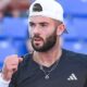Jacob Fearnley clenches his fist in celebration after winning a point