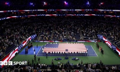 A giant flag is unfurled on the Arthur Ashe Stadium on the 25th anniversary of the 9/11 attacks