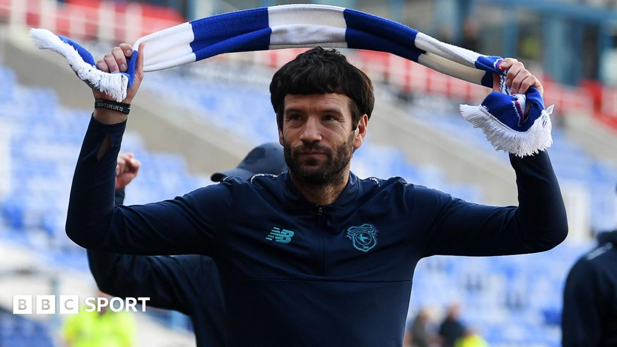 Brian Barry-Murphy swings a scarf above his head after guiding Cardiff to promotion from League One.