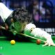 Snooker player Wu Yize takes aim as he plays a shot
