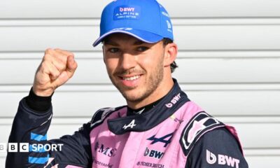 Alpine's Pierre Gasly poses with a picture of the '1' board after taking pole position at the Italian Grand Prix