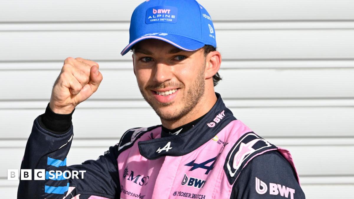 Alpine's Pierre Gasly poses with a picture of the '1' board after taking pole position at the Italian Grand Prix