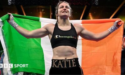 Katie Taylor holds the Ireland flag over her shoulders