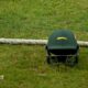 A green Leicestershire team helmet on the ground next to the boundary rope