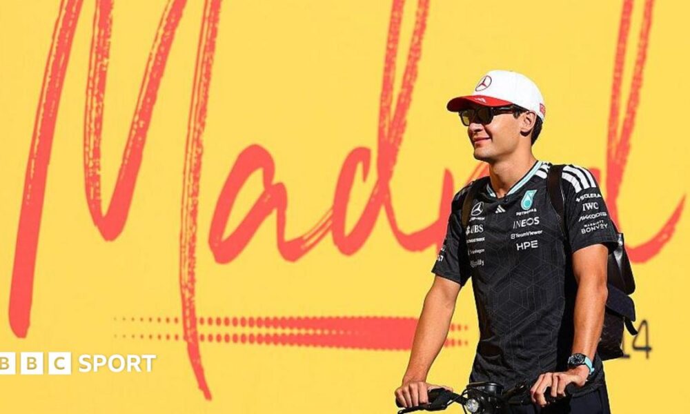 George Russell scoots past a Madrid sign