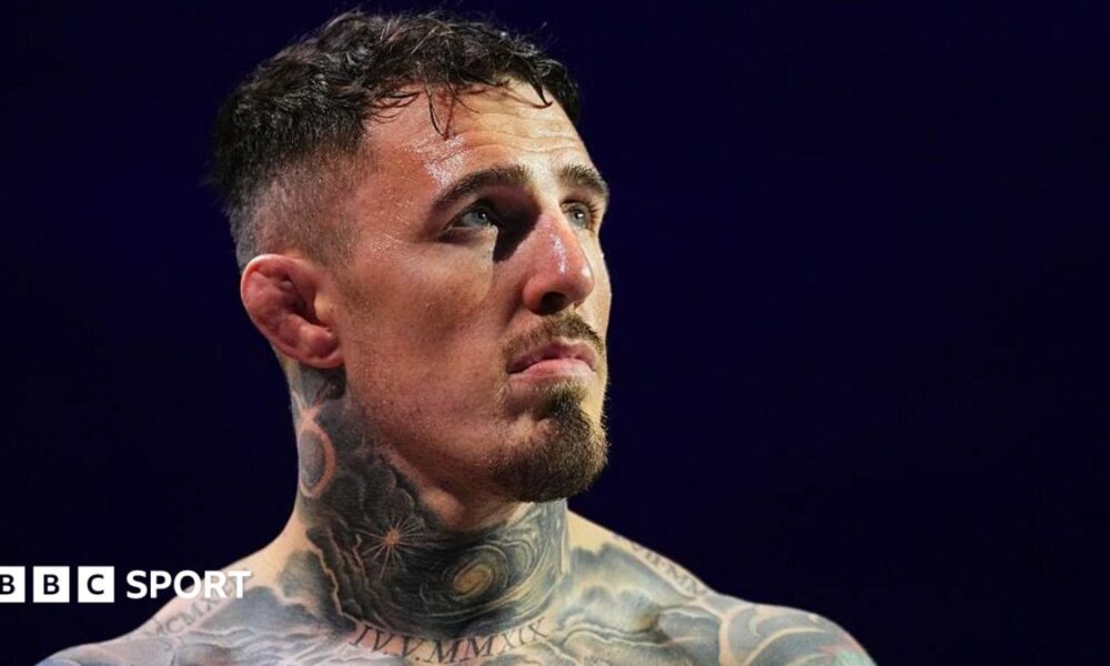 Head and shoulders view of heavily tattooed Tom Aspinall