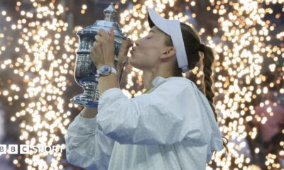 Elena Rybakina lifts the US Open trophy with Aryna Sabalenka looking on