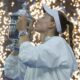 Elena Rybakina lifts the US Open trophy with Aryna Sabalenka looking on