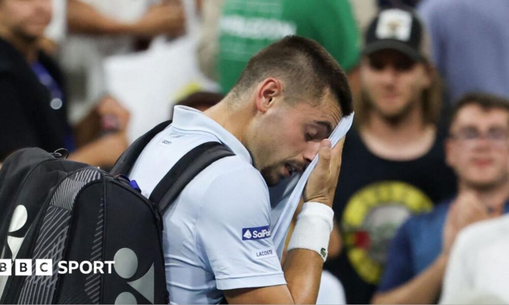 Arthur Gea wipes his face as he walks off court at the US Open